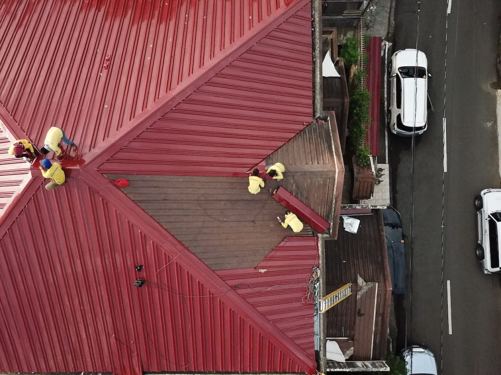 aerial view of roofers repairing roof